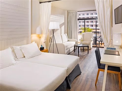 Junior Suite met een zithoek, een slaapbank en twee bedden in één ruimte bij H10 Conquistador in Playa de las Américas